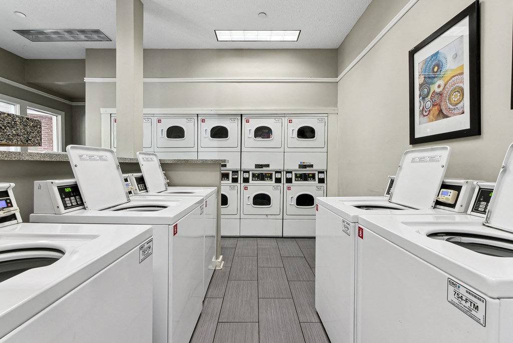 Laundry Facility A row of washing machines in a laundromat at Elme Druid Hills, Atlanta, Georgia